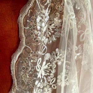 Cathedral length white wedding veil with floral and silver sequin detail